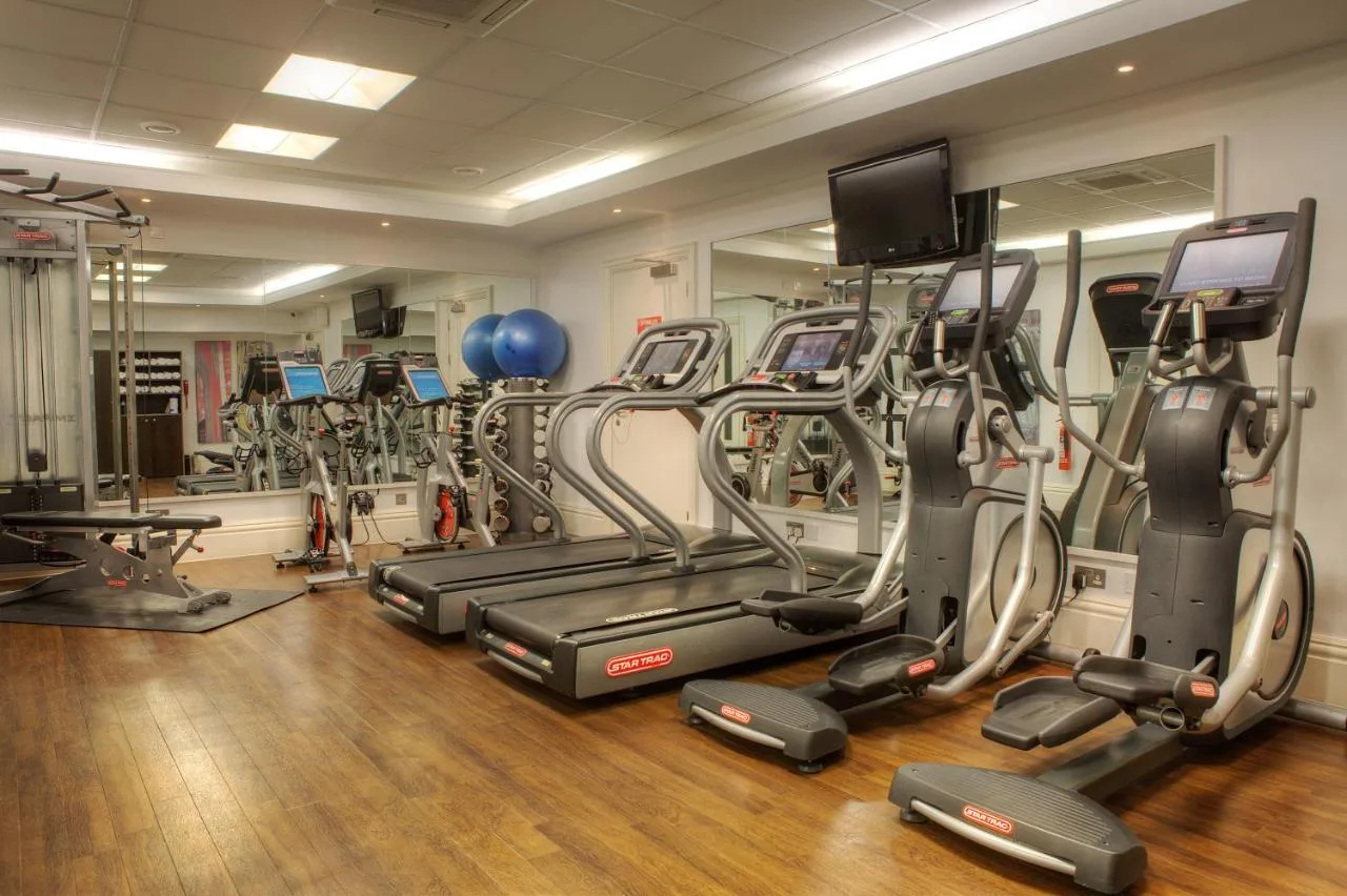 a gym with a bunch of treadmills and machines at Hotel Indigo Glasgow by IHG in Glasgow